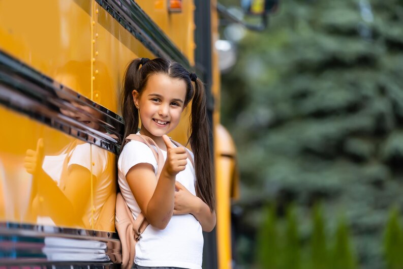 [freepicdownloader.com]-girl-with-backpack-near-yellow-school-bus-transport-students-medium.jpg